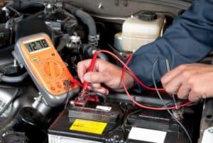 Multimeter testing car battery at Diamond Creek Shopping.