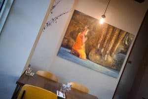 Serene dining area featuring Buddha art at Diamond Creek Shopping.