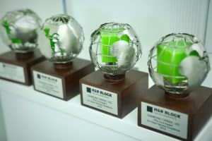 Shining chrome globe awards on wooden bases at Diamond Creek Shopping center.