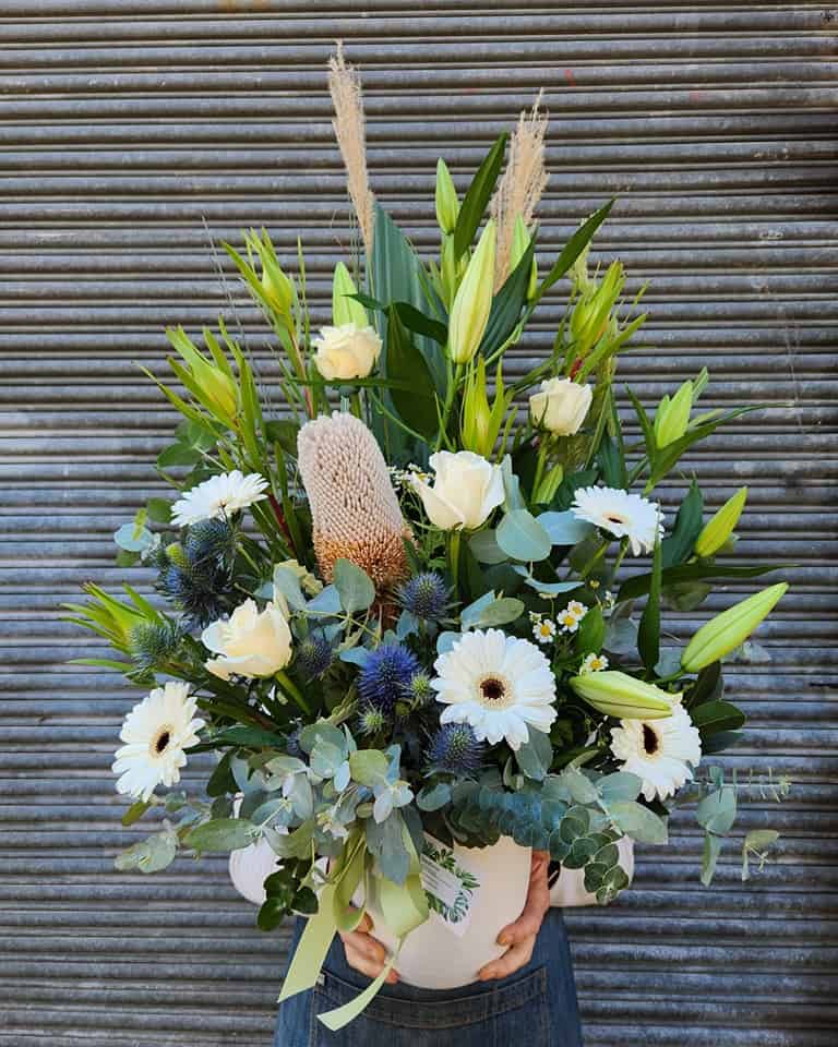 Vibrant white and blue floral arrangement at Diamond Creek Shopping, perfect for gifts.