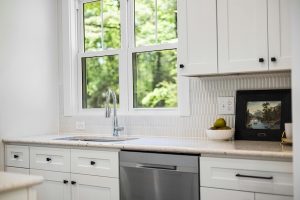 Plumber installing a dishwater