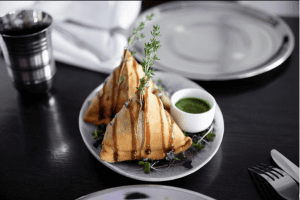 Delicious Indian samosas served with green sauce at Diamond Creek Shopping.