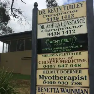 Local shopping centre sign featuring healthcare and medical professionals in Diamond Creek.