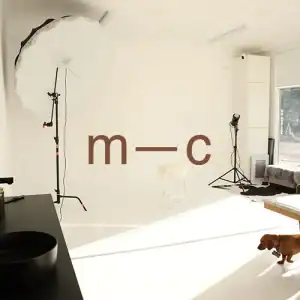Bright photography studio with professional lighting setup.