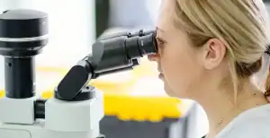 Female healthcare professional examining samples at Melbourne Pathology, Diamond Creek.