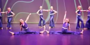 Group of young dancers performing on stage at Nicole Taylor Academy of Dance.