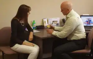 Man and woman during a chiropractic consultation at Synon Chiropractic in Diamond Creek.