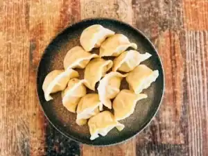 Delicious Chinese dumplings served on a black plate at Diamond Creek Shopping.