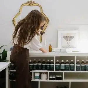 Woman selecting natural remedies at Diamond Creek Natural Medicine Centre.
