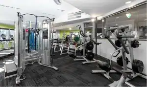 Indoor gym with various exercise machines at Diamond Creek Shopping.