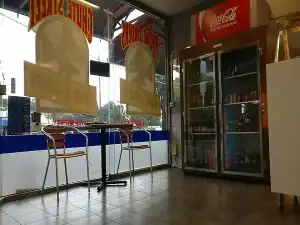Interior view of Diamond Creek Fish and Chips shop with seating area and beverage fridge.