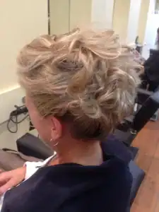 Curly blonde updo hairstyle at Dzine Hair Studio, Diamond Creek Shopping.