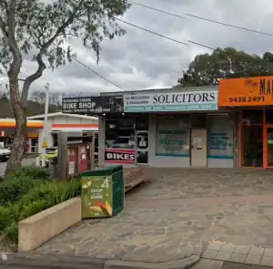 Shopfront of Diamond Creek Shopping with Ian McCubbin Solicitors signage.