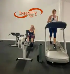 Infinity 360 gym, women using treadmill and rowing machine for fitness training.