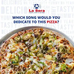 Delicious pizza topped with cheese, olives, and fresh vegetables at La Sera in Diamond Creek.