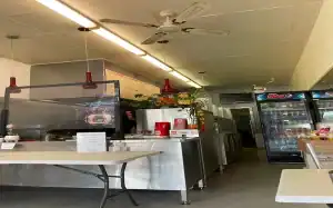 Interior view of Diamond Creek Shopping Centre food court with noodle bar and seating.