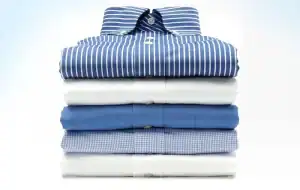 Stacked blue and white dress shirts at Diamond Creek Shopping, perfect for dry cleaning.