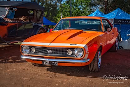 Orange Chevrolet Camaro at CarFest event in Diamond Creek.