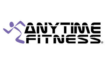 Modern gym interior at Anytime Fitness with workout equipment and bright lighting.