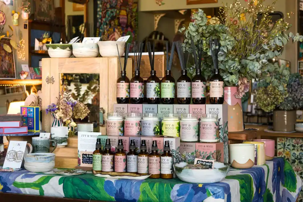 Display of essential oils, candles, and natural wellness products at Diamond Creek Shopping.
