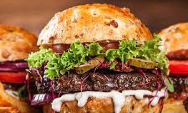 Delicious gourmet burger with fresh vegetables and sauce at Diamond Creek Shopping.