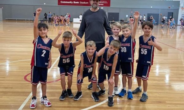 Youth basketball team with coach in indoor sports facility in Diamond Creek Victoria.
