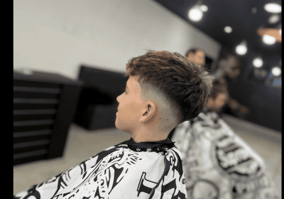 Young boy with fresh haircut at Diamond Creek Shopping barber shop.