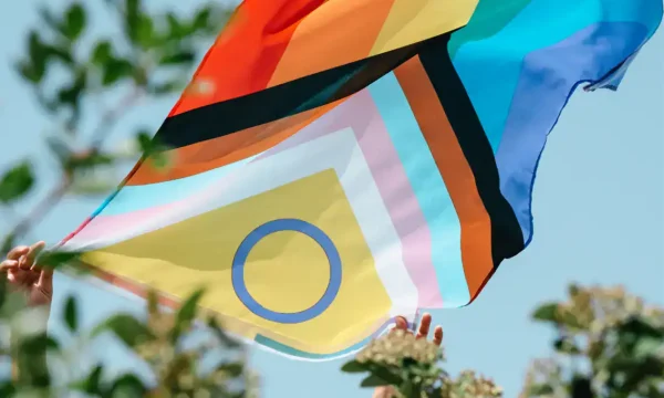 Colorful rainbow pride flag waving outdoors at Diamond Creek Shopping.